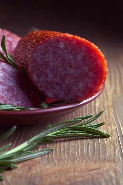 Salami and rosemary — Stock Photo, Image