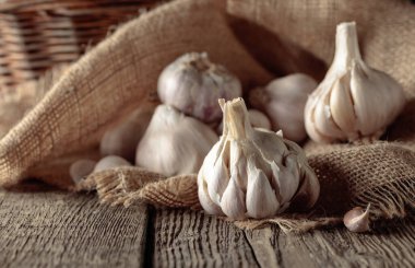 Garlic bulbs on an old wooden table.