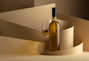 Bottle and glass of white wine on a beige background. Copy space.
