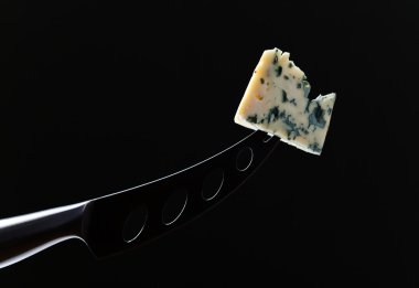 Gorgonzola on a black background clipart