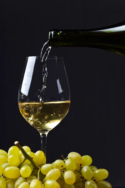 Vin som helles i et vinglass – stockfoto