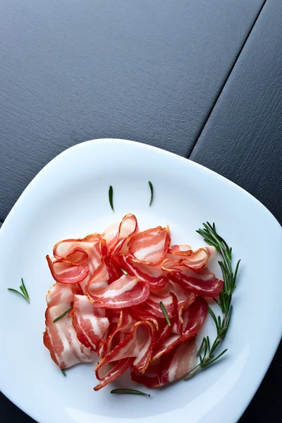 Bacon with rosemary — Stock Photo, Image