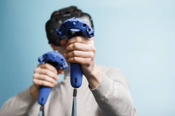 Young Man Plays Virtual Reality Glasses Computer Games Blue Background — Stock Photo, Image