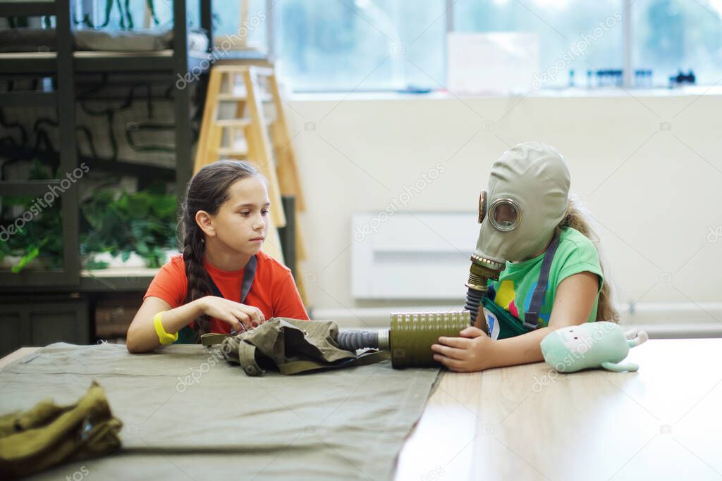 Girls in gas masks in civil defense classes. Selective focus.