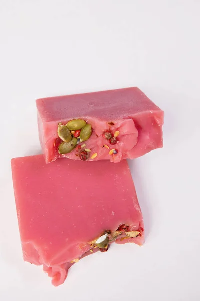 Handmade homemade soap in female hands. Cherry cider flavor. Small business, organic products, natural ingredients. Top view.