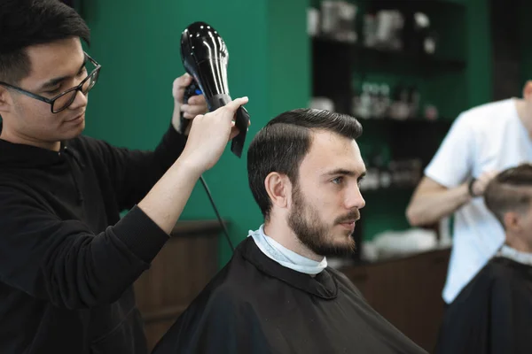 Master Dries His Hair Hairdryer Bearded Guy Hairdressing Chair Barbershop — Stock Photo, Image