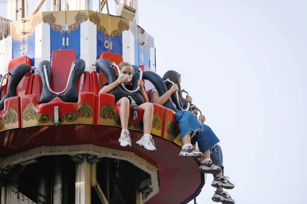 Extreme attraction - free fall tower in summer amusement park in the city. The concept of urban recreation, fun, leisure.