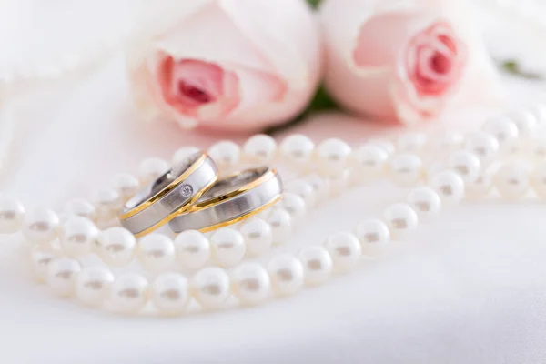 Modern Wedding Rings Pearl Necklace Wih Pink Roses Background Soft Stock Photo