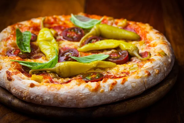 Homemade pizza with dried tomatoes and hot peppers — Stock Photo, Image