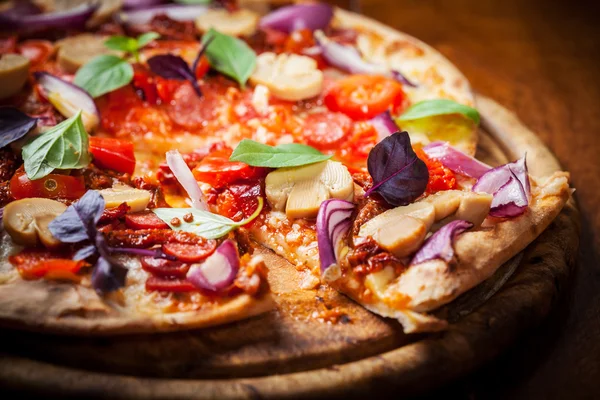 Homemade pizza with dried tomatoes and salami — Stock Photo, Image