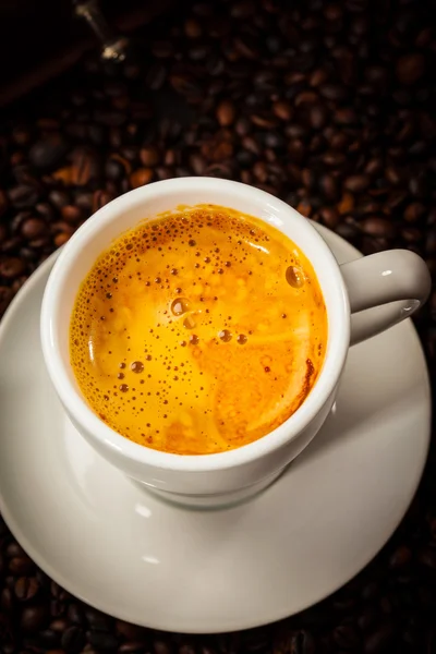 Espresso cup in coffee beans — Stock Photo, Image