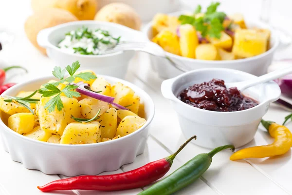 Baked potatoes with chutney and sour cream — Stock Photo, Image
