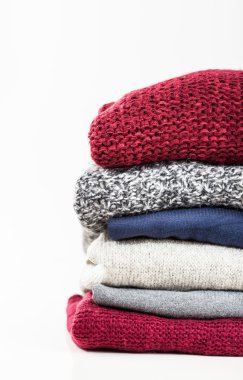 Stack of handmade wool sweaters clipart