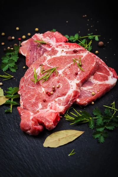 Fresh raw meat on black board — Stock Photo, Image