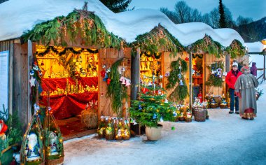 Karlı Noel Pazarı, yanan dükkanlar ahşap kulübelerde hediyeler ve el yapımı dekorasyonlar..