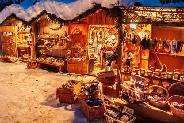 ギフトや手作りの装飾が施された木製の小屋でライトアップされたお店で雪のクリスマスマーケット — ストック写真