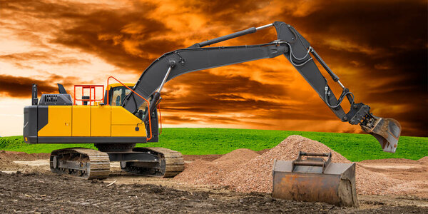 earth mover and excavator at work in construction site
