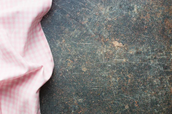 Pink checkered napkin on old table — Stock Photo, Image