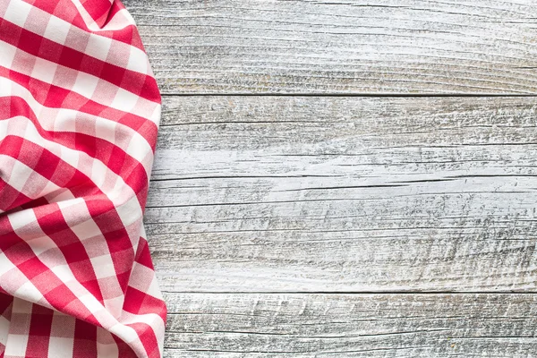 Checkered napkin on old table — Stock Photo, Image