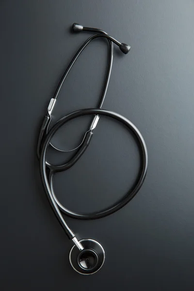 Stethoscope on black table. — Stock Photo, Image