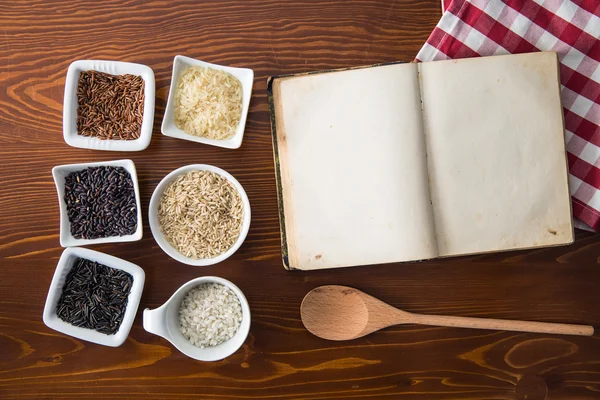 Livro de receitas em branco e diferentes variedades de arroz . — Fotografia de Stock