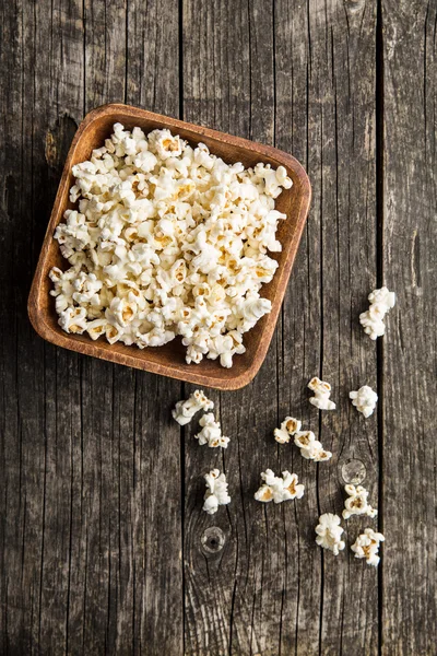 Popcorn on wooden table. — Stock Photo, Image