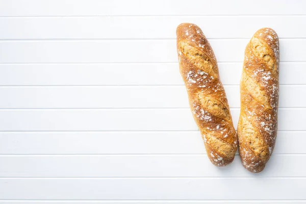 Two Crispy Fresh Baguettes White Table Top View — Stock Photo, Image