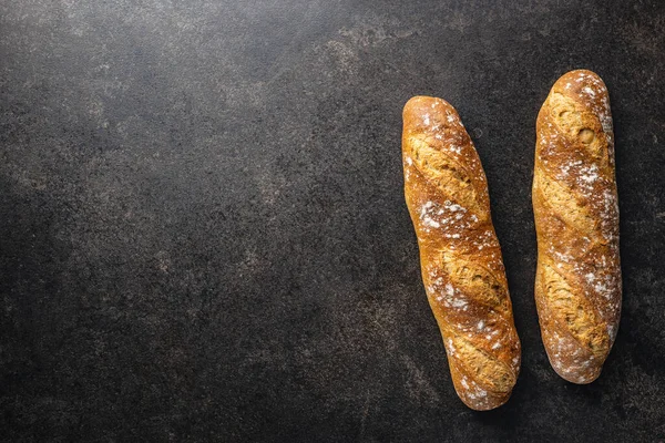 Crispy Fresh Baguettes Black Table Top View — Stock Photo, Image