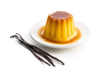 Sweet vanilla pudding and vanilla pods. Sweet dessert with caramel topping isolated on white background. clipart