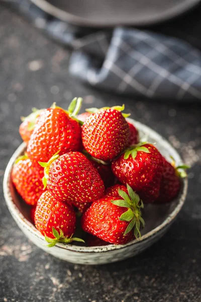 厨房桌子上的碗里放满了成熟的红草莓 — 图库照片