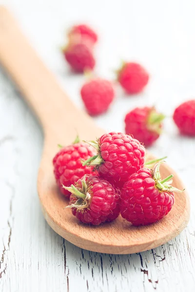 Raspberries on wooden spoon — Stock Photo, Image