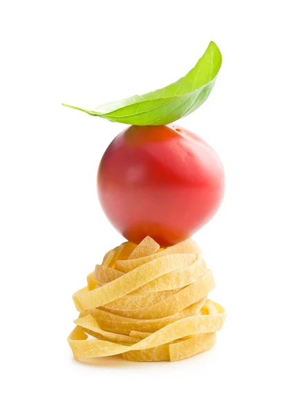 Italian pasta tagliatelle, tomato and basil leaf — Stock Photo, Image