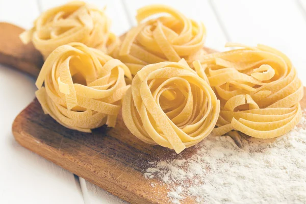 Italian pasta tagliatelle and flour — Stock Photo, Image