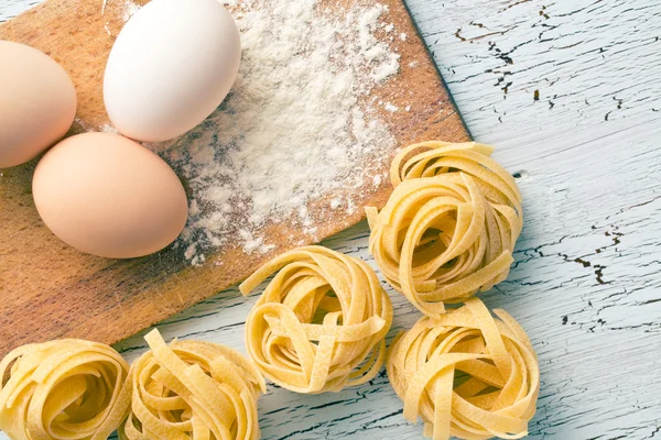 Tagliatelle de pasta italiana, huevos y harina —  Fotos de Stock