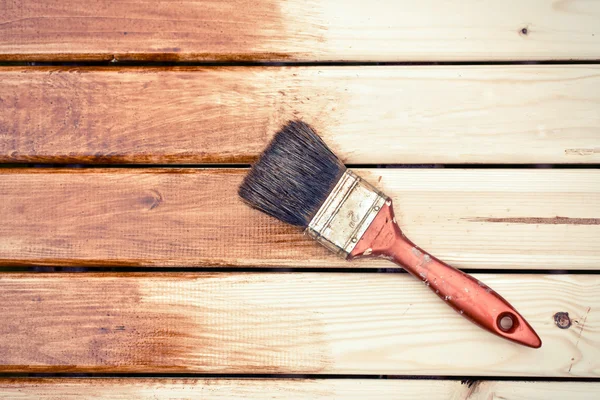 Painting wooden table using paintbrush — Stock Photo, Image