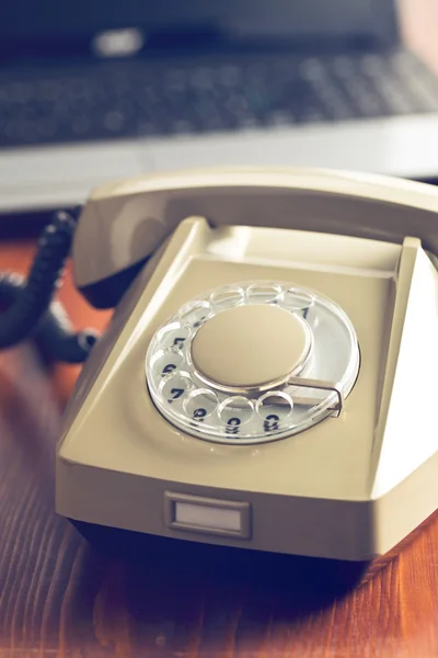 Retro phone and modern laptop — Stock Photo, Image