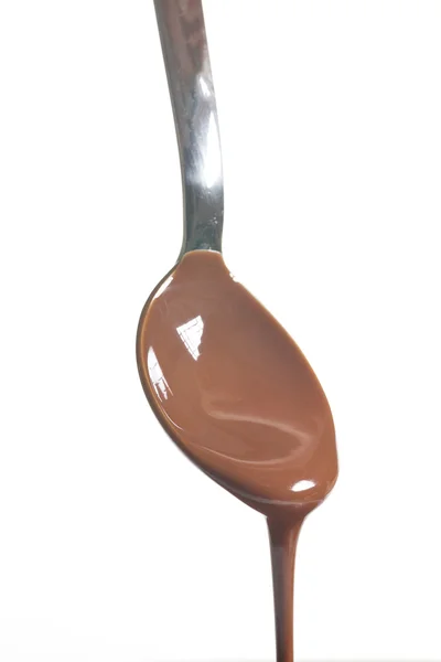 Chocolate poured into a spoon — Stock Photo, Image