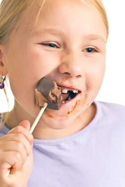 Child eating chocolate lollipop — Stock Photo, Image