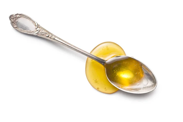 Miel dulce en cuchara de plata — Foto de Stock