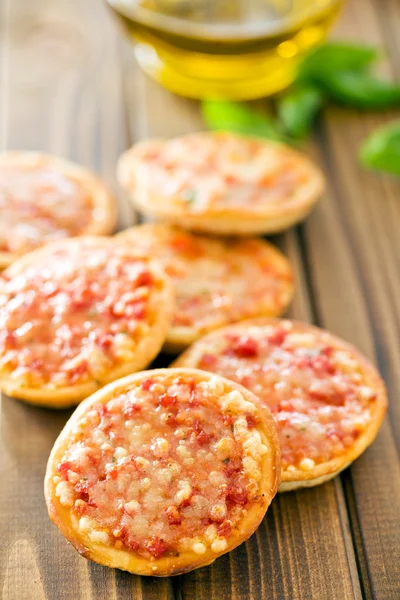 Mini pizza on wooden table — Stock Photo, Image