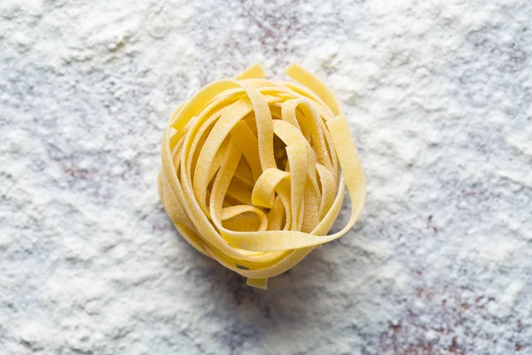 Raw pasta and flour — Stock Photo, Image