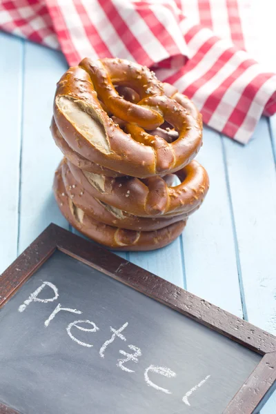 Baked pretzels and chalkboard — Stock Photo, Image
