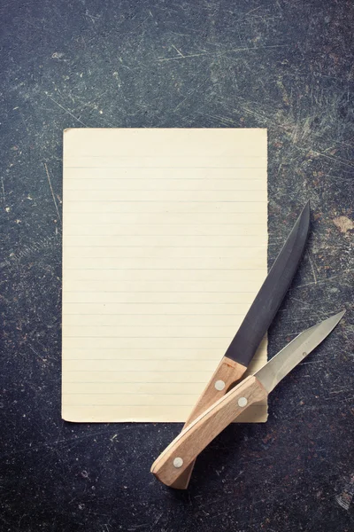 Sheet of paper with knives — Stock Photo, Image