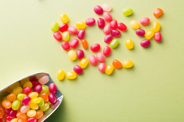 Jelly beans on green table — Stock Photo, Image