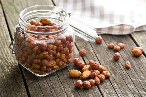 Various sugared nuts in jar — Stock Photo, Image