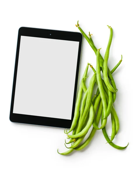 Zelené fazolky a počítač tablet — Stock fotografie