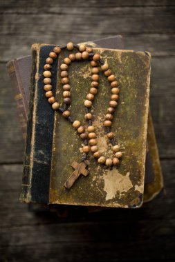 vintage rosary beads on old book clipart