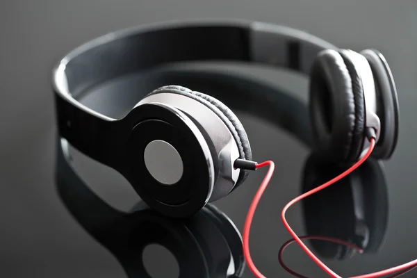 Headphones on black table — Stock Photo, Image