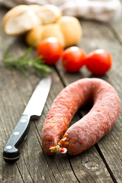 Chorizo sausage on wooden table — Stock Photo, Image