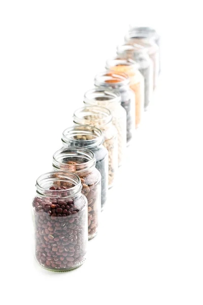 Various dried legumes in jars — Stock Photo, Image